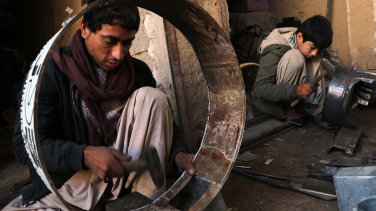 Afghan men prepare traditional heaters in preparation for the cold winter ahead