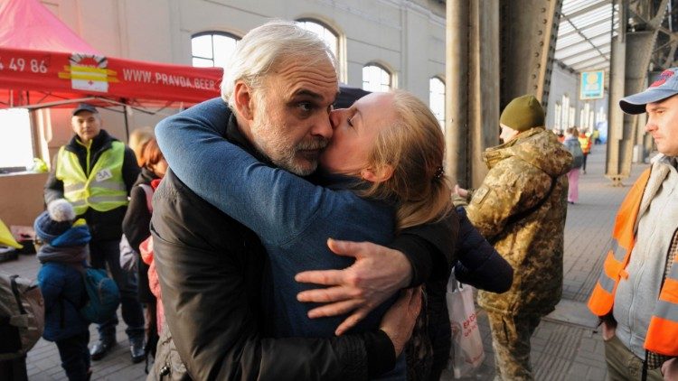 Į Lenkiją išvykstanti moteris atsisveikina su savo vyru, liekančiu Ukrainoje (kovo 15 d.)