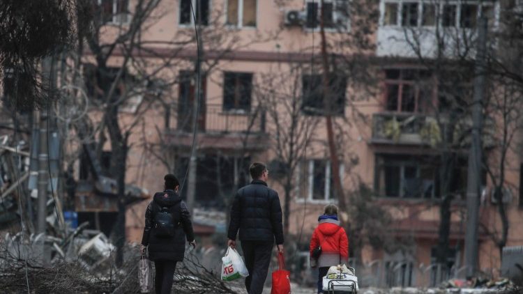 Local people walk on the Mira avenue in downtown of Mariupol, Ukraine, 12 April