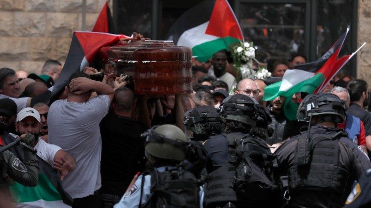 Mourners carry the coffin of Shireen Abu Akleh outside St. Joseph Hospital