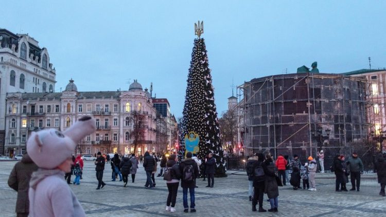 People gather around a Christmas tree in Kyiv's Sophia Square. Ukrainians are preparing to celebrate Christmas despite the ongoing Russian invasion.
