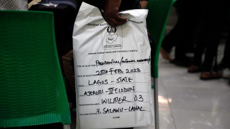 An electoral officer waits in line to submit election results at the Independent Electoral Commission