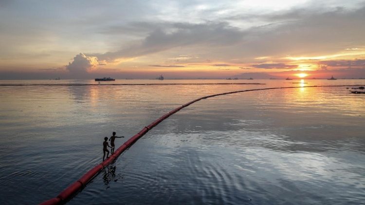 Children play in Manila Bay in the Philippines