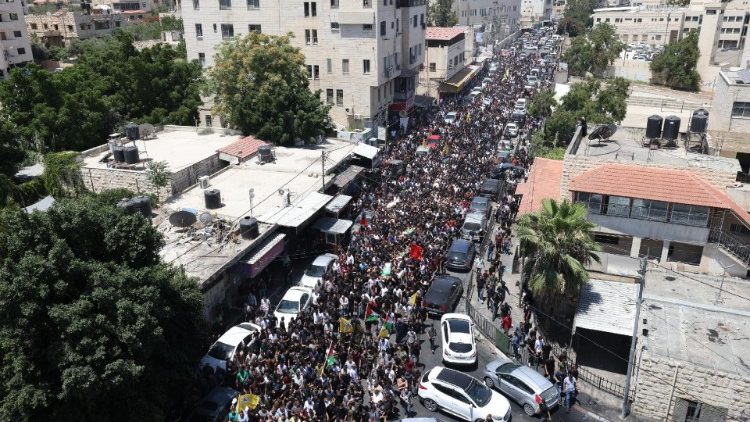 Hundreds of Palestinian mourners join a funeral procession in Jenin