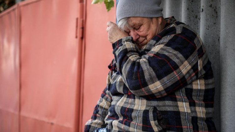 A local resident mourns near her home after a Russian military strike hit the village of Hroza in northeastern Ukraine