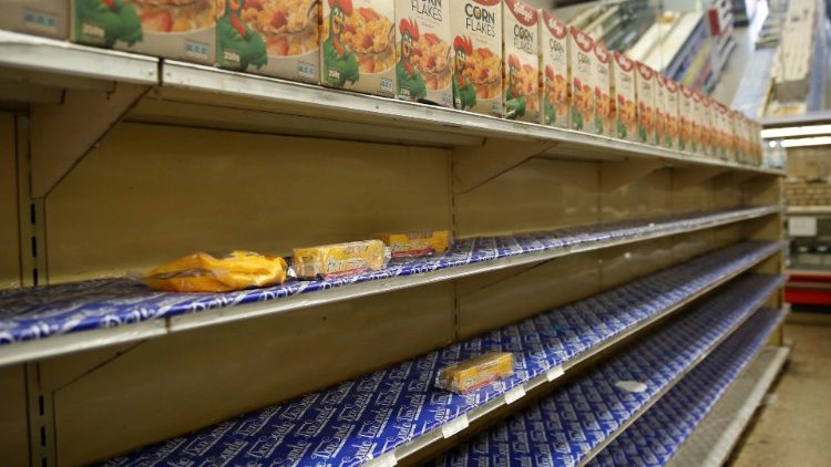 Bare shelves are seen at a local shop in Caracas