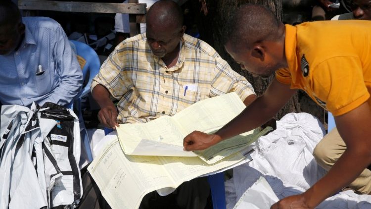men-examine-voting-materials-at-ceni-tallying-1546360750057.JPG