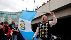 a-man-holds-a-guatemalan-flag-during-a-protes-1546877049939.JPG