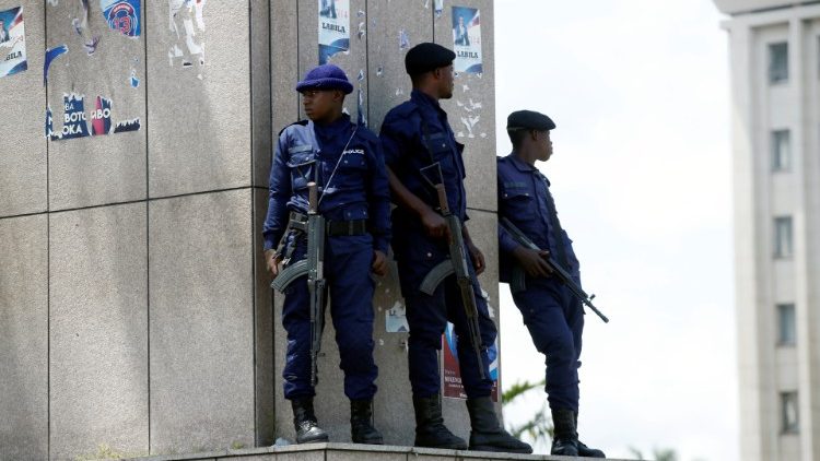 Congolese policemen take positions near Congo's Independent National Electoral Commission (CENI) headquarters in Kinshasa