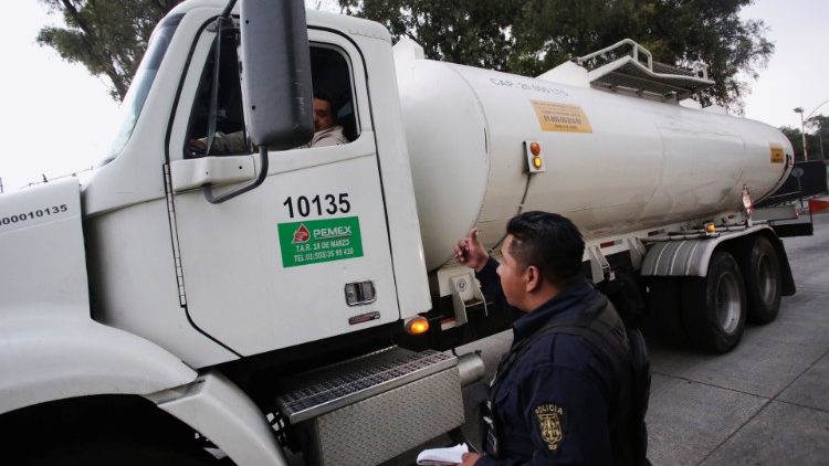 A police officer talks to a fuel truck driver in Mexico City