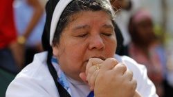 a-nun-prays-outside-as-pope-francis-holds-a-m-1548526455999.JPG