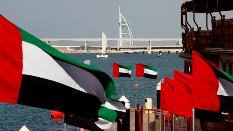 FILE PHOTO: UAE flags fly as the Burj al-Arab luxury hotel is seen in the background during the UAE's National Day in Dubai