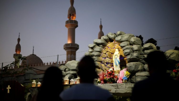 Expat worshippers pray in front of St. Mary's shrine at St. Mary's Catholic church in Oud Metha in Dubai