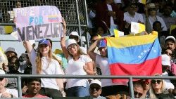 women-hold-a-venezuelan-flag-and-a-sign-as-th-1549344834215.JPG
