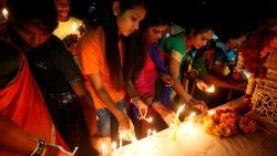 people-light-candles-at-a-memorial-during-a-v-1550588640581.JPG