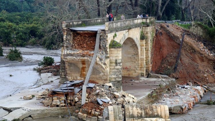 People stand on the destroyed Keritis bridge following flash floods near the village of Alikianos, on the island of Crete