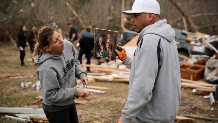 A family photograph sits placed on the remains of a tree outside a destroyed home after two deadly back-to-back tornadoes, in Beauregard, Alabama