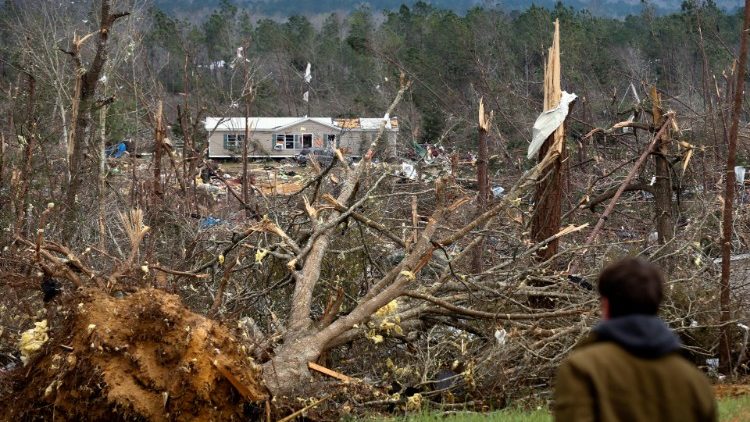 A house  across a hillside of wreckage after back-to-back tornadoes in Alabama 