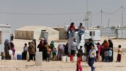 file-photo--syrian-refugees-collect-water-at--1551961270713.JPG
