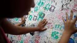 students-place-their-handprints-on-a-wall-at--1552669154252.JPG