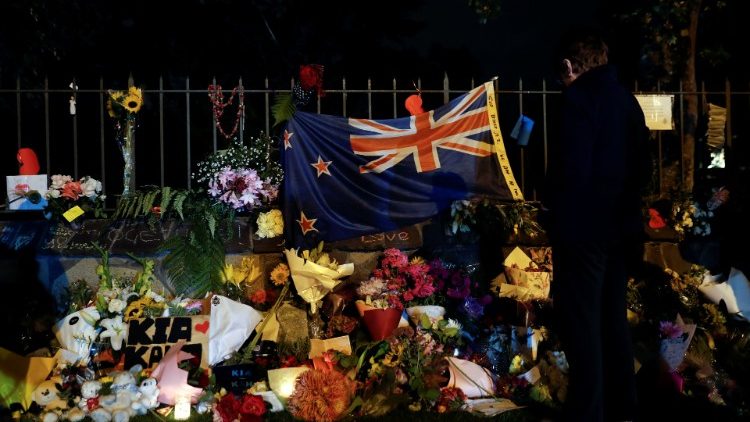 People pay their respects at a memorial site for victims of the mosque shootings at the Botanic Gardens in Christchurch
