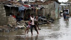 a-man-carries-his-children-after-cyclone-idai-1553359151904.JPG