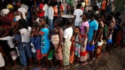people-queue-for-food-in-a-camp-for-those-dis-1553683476336.JPG