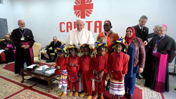 Pope Francis poses for a picture at Caritas' office in Morocco