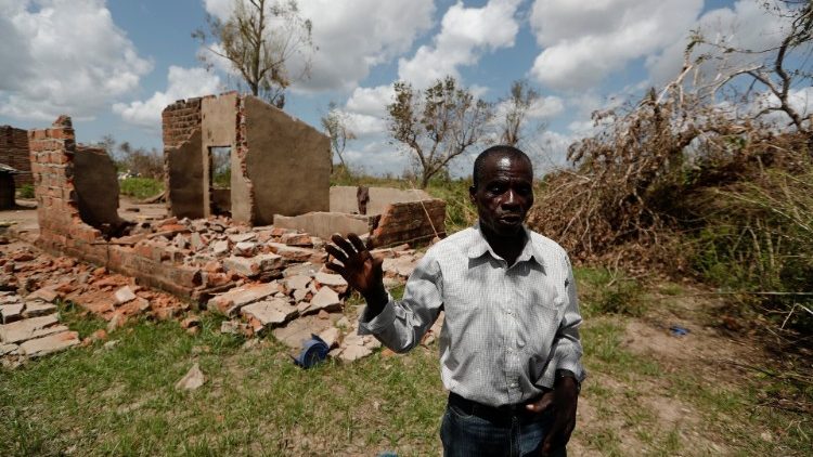 A Mozambican man in front of his damaged house in the village of Cheia, near Beira  