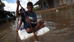 kids-are-pictured-at-a-flooded-street-during--1554906562772.JPG