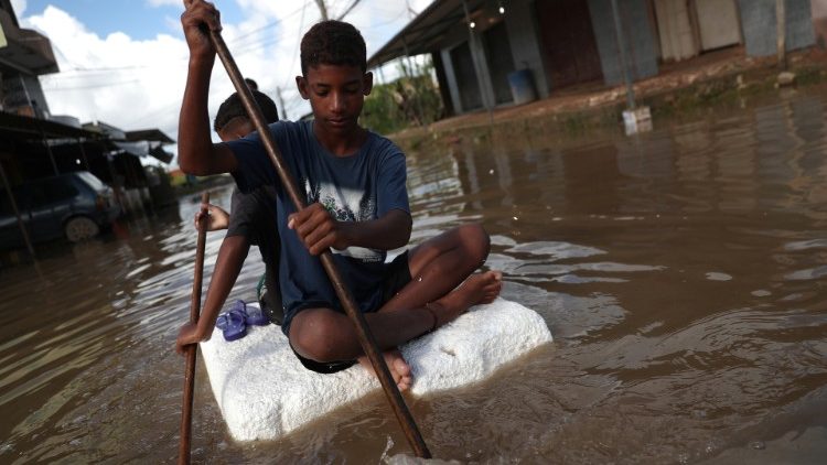 kids-are-pictured-at-a-flooded-street-during--1554906562772.JPG