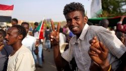 a-sudanese-demonstrator-flashes-a-two-finger--1555061947349.JPG