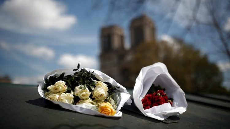 Bunches of roses are placed near Notre-Dame Cathedral two days after a massive fire devastated large parts of the gothic structure in Paris