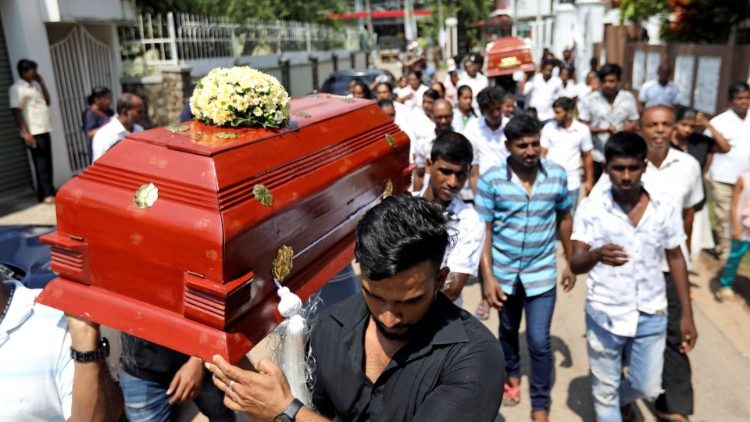 Friends and relatives carry the coffins of eight-month-old Mathew and his grandmother Agnes Vnikpridha, 69, who died during a string of suicide bomb attacks on churches and luxury hotels on Easter Sunday, at their funeral in Negombo