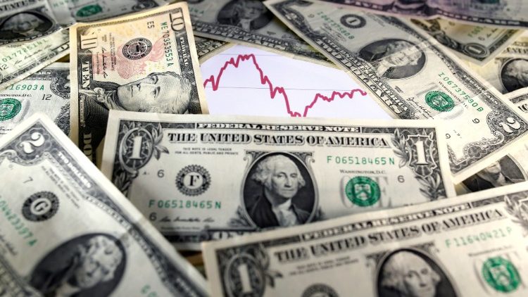 FILE PHOTO: U.S. dollar notes are seen in front of a stock graph in this picture illustration