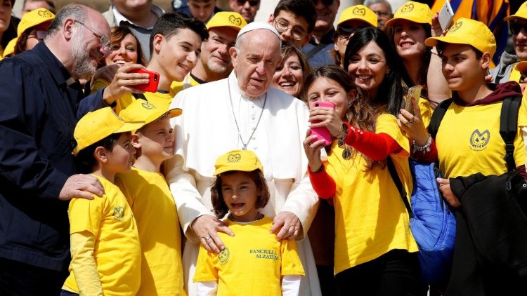 Pope Francis poses for a photo at the end of the weekly audience at the Vatican
