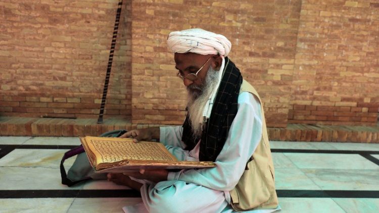 A man reads the Koran during the holy month of Ramadan at Mohabat Khan mosque in Peshawar
