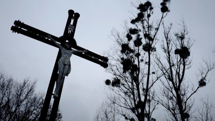 Cruz na proximidade de uma igreja em Kalinowka, Polônia