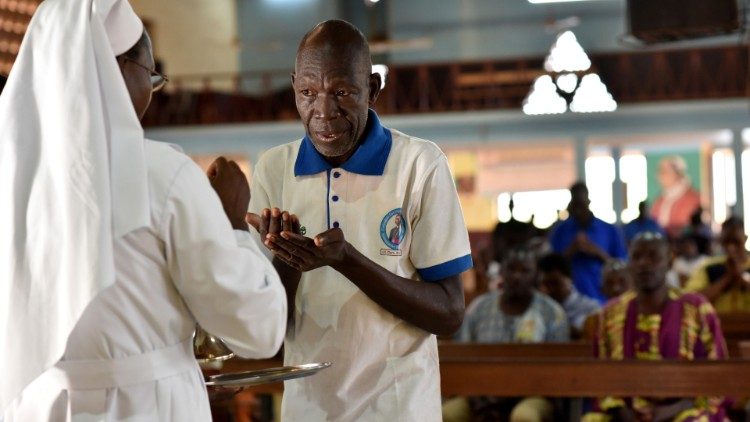 Fiel recebe a Comunhão na Catedral de Nossa Senhora de Kaya, cidade de Kaya, Burkina Faso