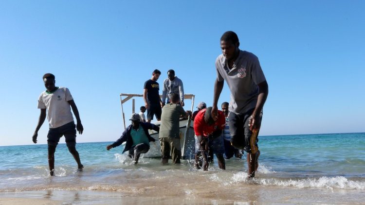 Migrants are seen after being rescued by Libyan coast guard in Tripoli