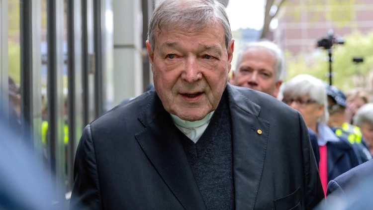 FILE PHOTO - Vatican Treasurer Cardinal George Pell is surrounded by Australian police as he leaves the Melbourne Magistrates Court in Australia