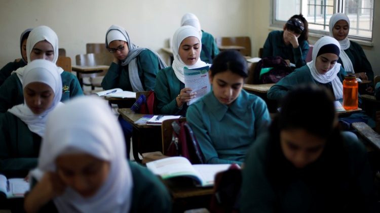 Students attend a class at one of the public schools during the first day after the end of teachers' one-month strike in Amman