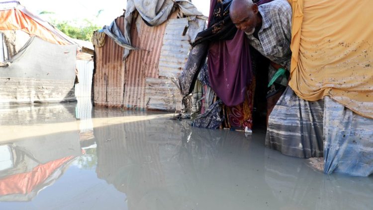 A Somali man looks out of his flooded shelter after heavy rain in Mogadishu