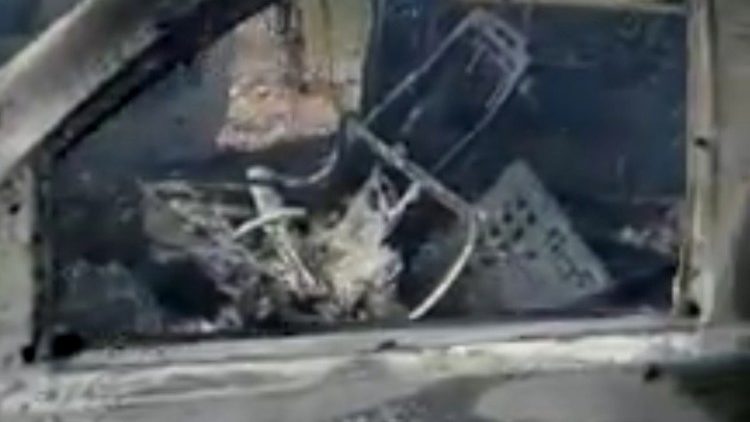 Burnt wreckage of a vehicle is seen in Bavispe, Mexico