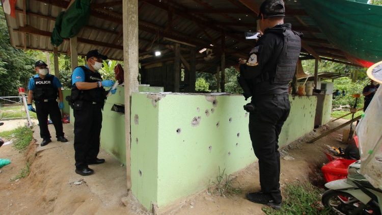 Thai forensic experts and military personnel examine the site where village defence volunteers were killed by suspected separatist insurgents in Yala province