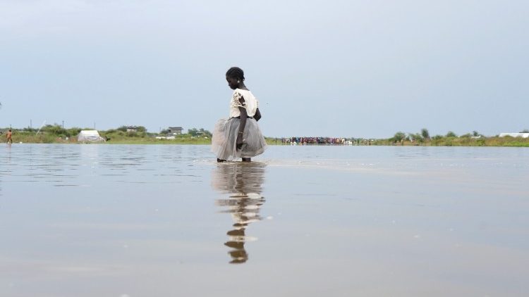 A girl walks in water, in the town of Pibor, Boma state