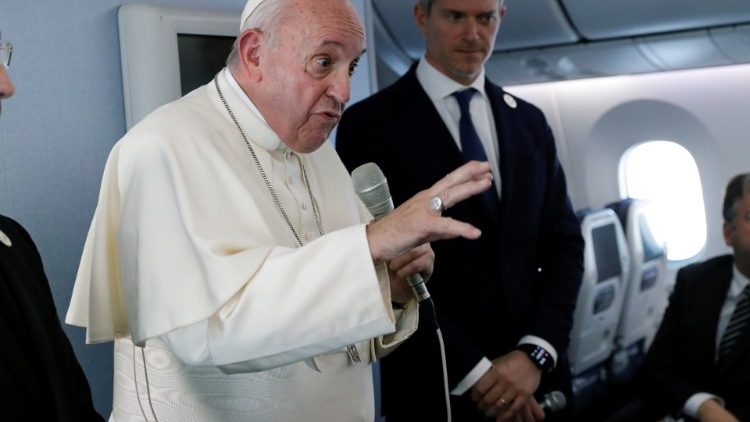 Pope Francis speaks during a news conference onboard the papal plane on his flight back from a trip to Thailand and Japan