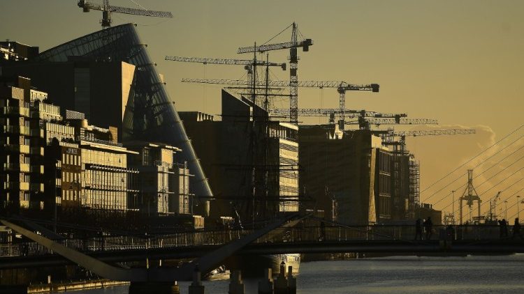 FILE PHOTO: Construction cranes are seen at sunrise in the financial district of Dublin
