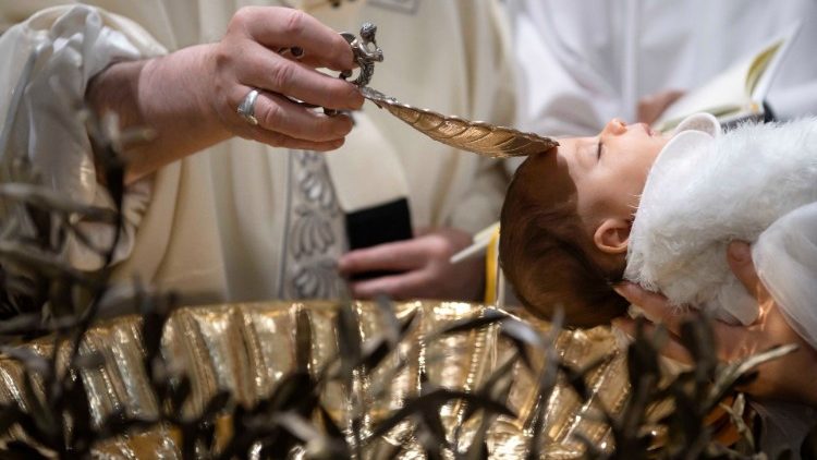 Pope Francis baptises a baby during a Mass in the Sistine Chapel at the Vatican