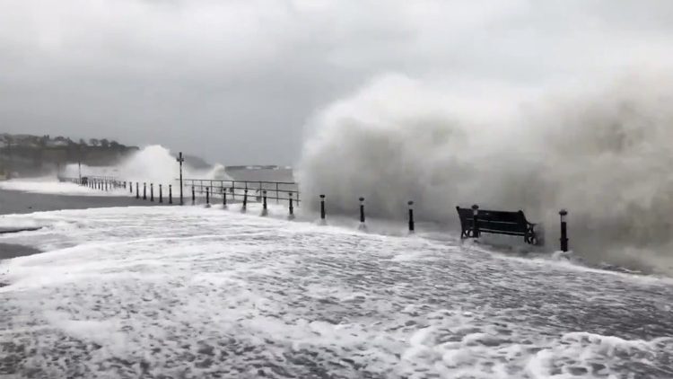 Waves crash against the pier during a windy day in Whitehead